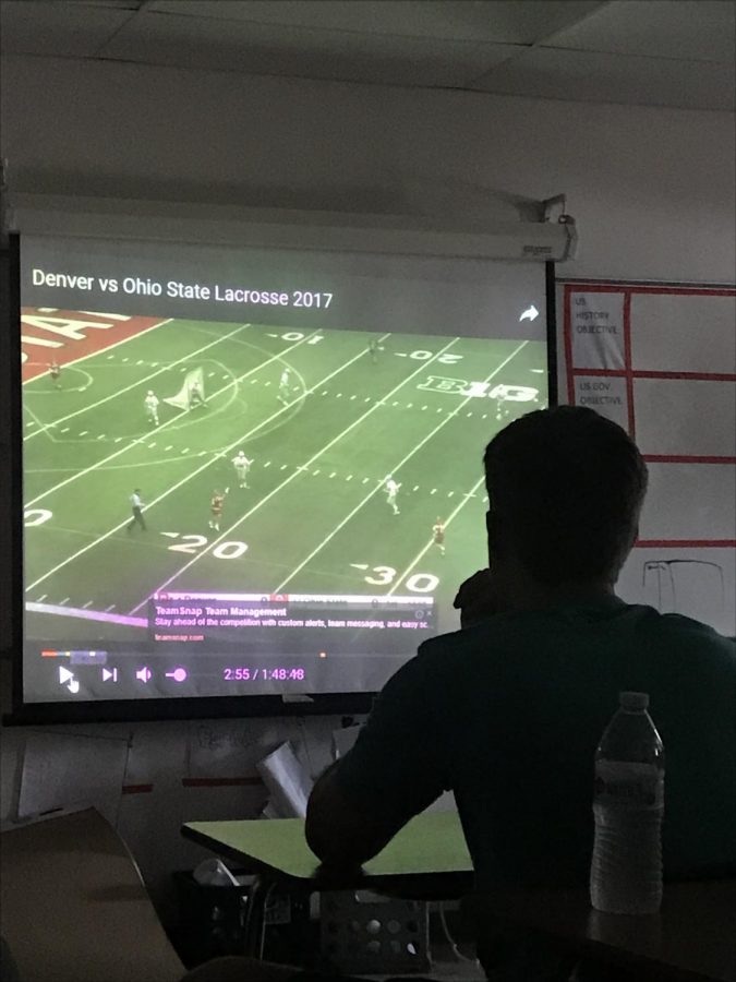 As part of their training, the boys LAX team watches videos of college lacrosse teams.