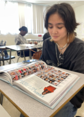 Abby Araniego checks her cope of the 2022 Glory Yearbook. 